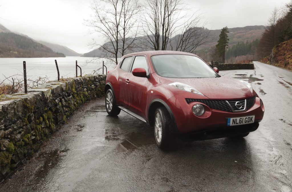 a car in front of water in the lakes